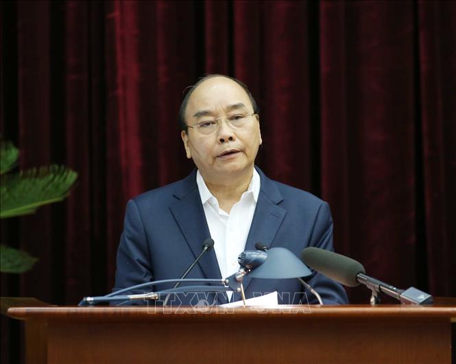 Thủ tướng Chính phủ Nguyễn Xuân Phúc trình bày báo cáo tại hội nghị