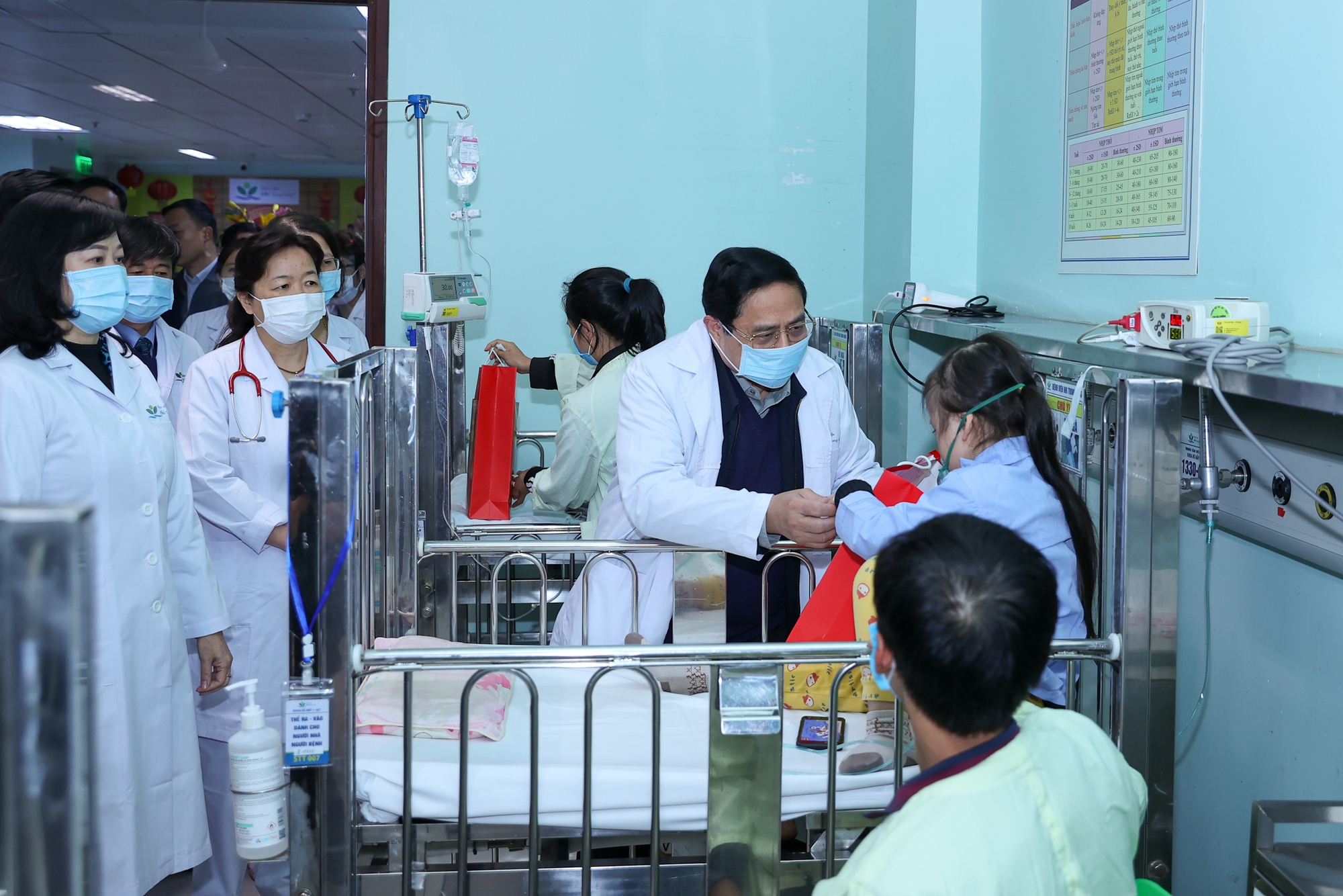 Thủ tướng Phạm Minh Chính tặng quà và chia sẻ với các bệnh nhân, người nhà bệnh nhân vẫn phải ở bệnh viện mà không được về nhà đón Tết - Ảnh: VGP/Nhật Bắc
