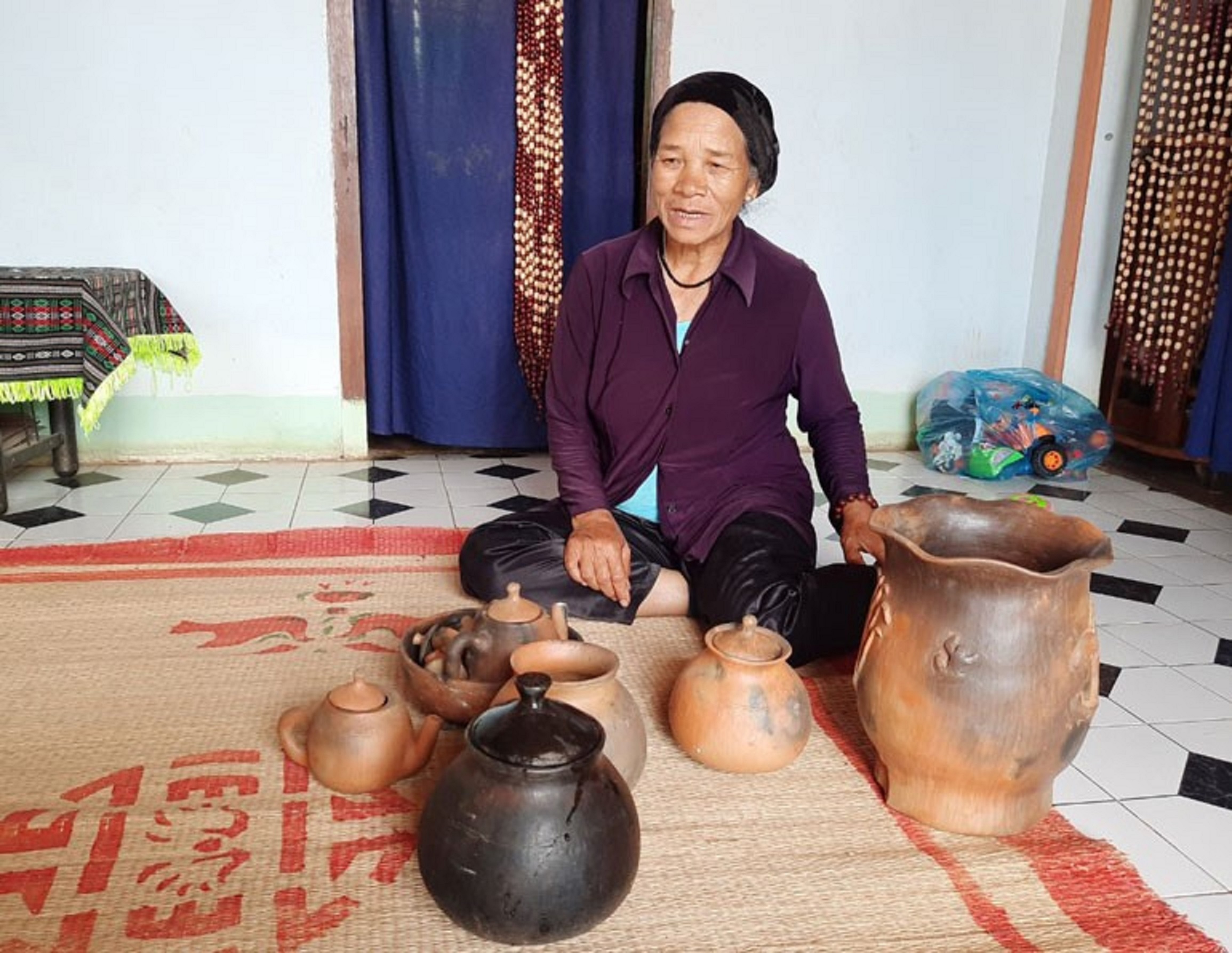 Nghệ nhân Ma Li giới thiệu các sản phẩm gốm mộc truyền thống của đồng bào Chu Ru.