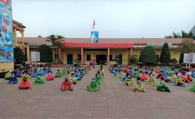 Các em học sinh mầm non ở một trường tại Hải Dương mặc áo mưa chuẩn bị đi cách ly tập trung trong đợt bùng phát dịch lần thứ ba hồi tháng 2/2021.