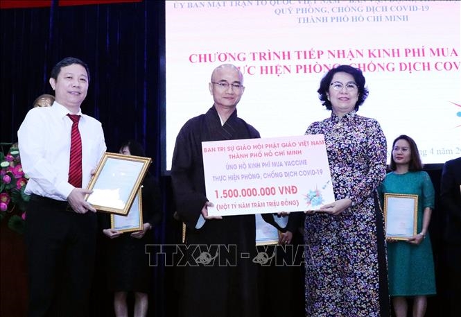 Thượng tọa Thích Thiện Quý, Chánh Thư ký Ban Trị sự Giáo hội Phật giáo Việt Nam TP Hồ Chí Minh (giữa) trao tượng trưng số tiền các tăng ni, phật tử Thành phố ủng hộ để mua vaccine phòng COVID-19.