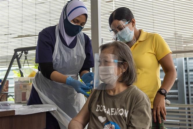Nhân viên y tế tiêm vaccine ngừa COVID-19 cho người dân tại Kuala Lumpur, Malaysia ngày 29/7/2021. Ảnh: THX/TTXVN