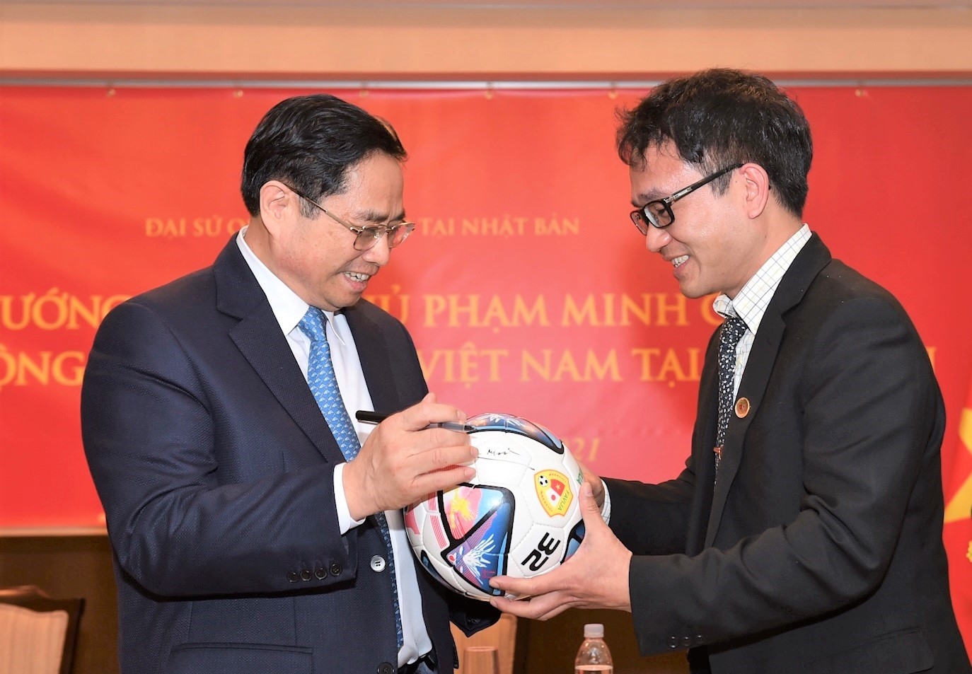 Thủ tướng ký tên lên quả bóng đá giải đấu giao hữu giữa cộng đồng người Việt tại Nhật. Ảnh: VGP/Nhật Bắc
