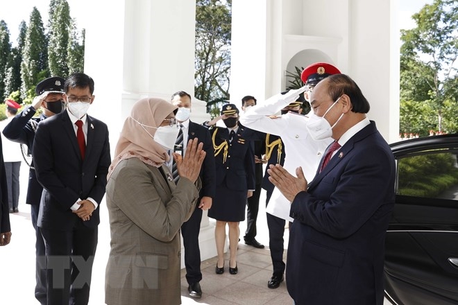 Tổng thống Cộng hòa Singapore Halimah Yacob đón Chủ tịch nước Nguyễn Xuân Phúc thăm cấp Nhà nước tới Singapore. (Ảnh: TTXVN) 