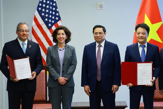 Thủ tướng Phạm Minh Chính cùng Bộ trưởng Thương mại Hoa Kỳ và thành viên đoàn chứng kiến lễ trao Giấy chứng nhận đầu tư và đăng ký kính doanh cho công ty TNHH kho cảng LNG Sơn Mỹ - Ảnh: VGP/Nhật Bắc