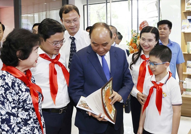 Chủ tịch nước Nguyễn Xuân Phúc và các đại biểu tham quan trưng bày ấn phẩm của Nhà xuất bản Kim Đồng