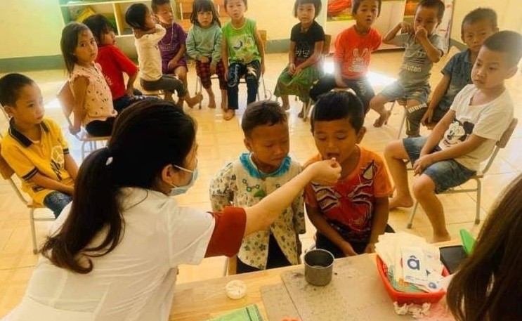 Bác sĩ Hà Thị Sanh cho các em học sinh mầm non uống vitamin theo định kỳ