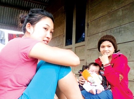 Thiếu nữ người Bhnoong Hồ Thị Hi (bên phải), xã vùng cao Phước Kim mới 18 tuổi đã có 2 con.