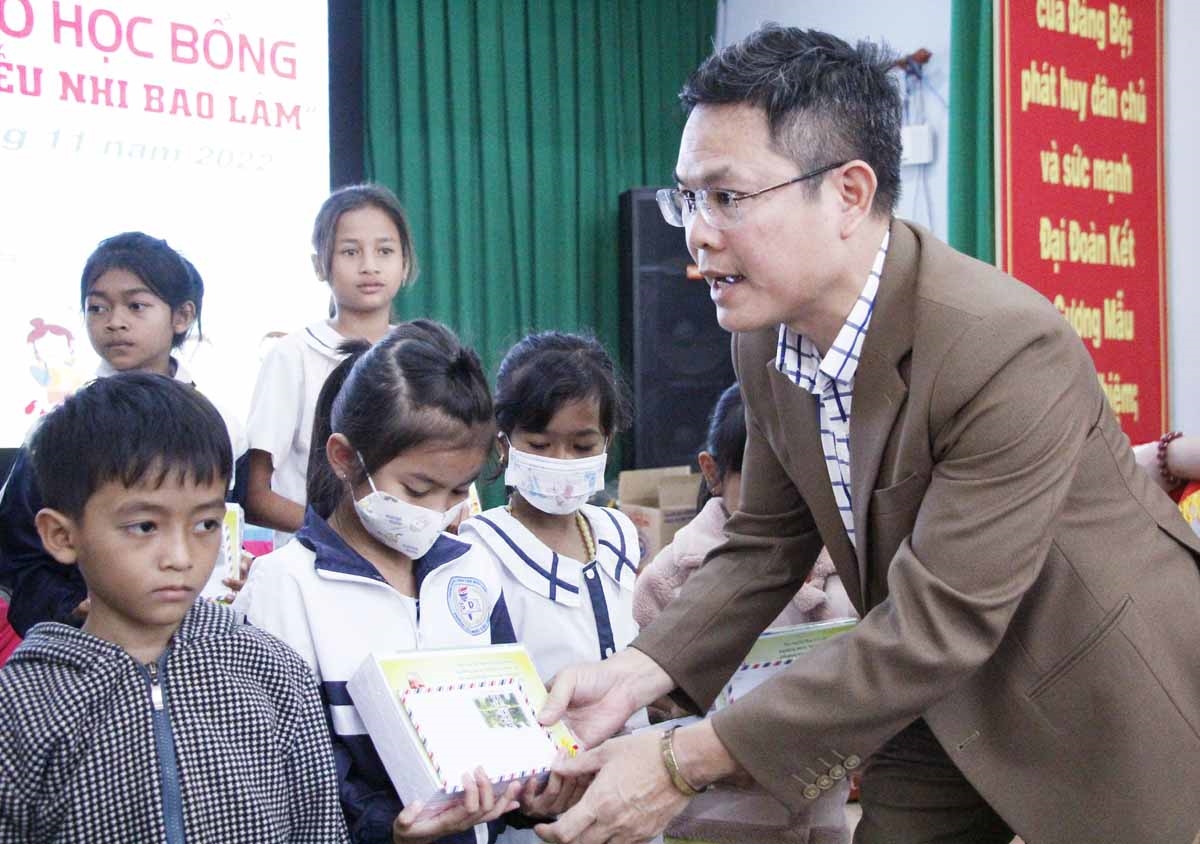 Đại diện Báo Dân tộc và Phát triển trao tặng các suất học bổng cho các em ở xã Lộc Thuận, Bảo Lâm