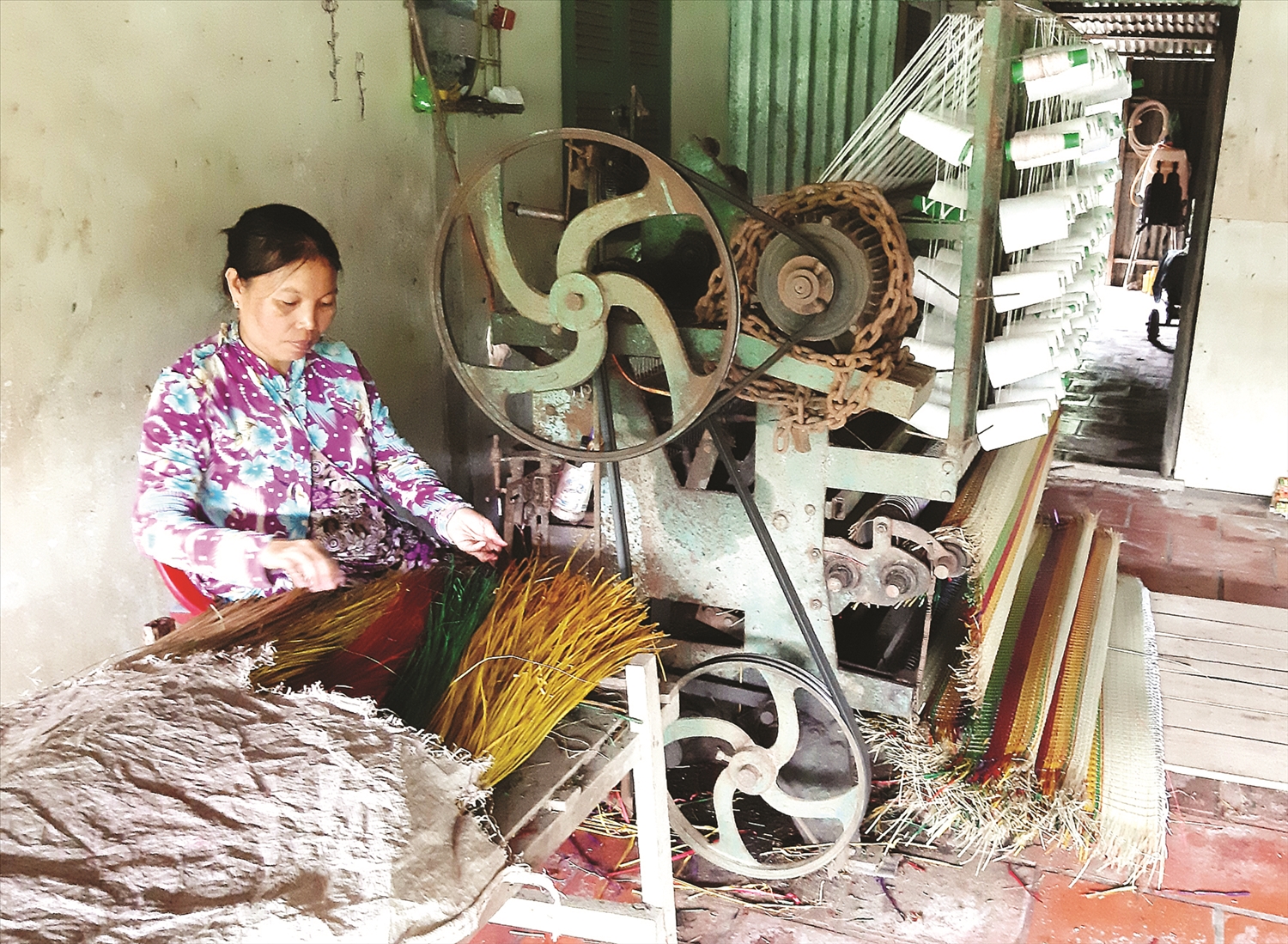 Chị Danh Kim Ánh, ấp Chợ (xã Hàm Tân) sử dụng máy dệt chiếu, nâng cao năng suất lao động, tăng thu nhập.