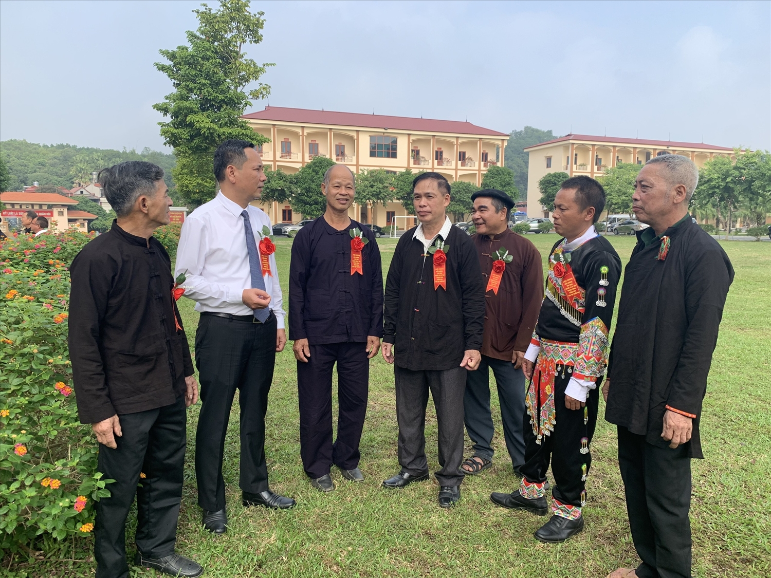 Đồng chí Trần Xuân Thủy, Trưởng Ban Dân tộc tỉnh Yên Bái (áo trắng) trò chuyện cùng các đại biểu Người có uy tín bên lề Hội nghị