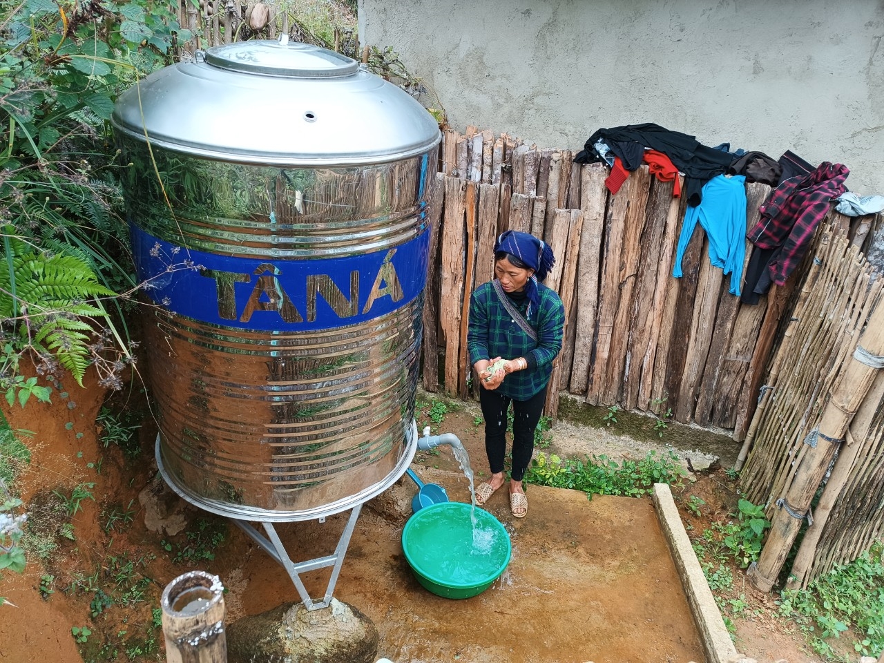 Người dân xã Nậm Pung sử dụng nước sạch từ bồn chứa được hỗ trợ theo CT MTQG 1719