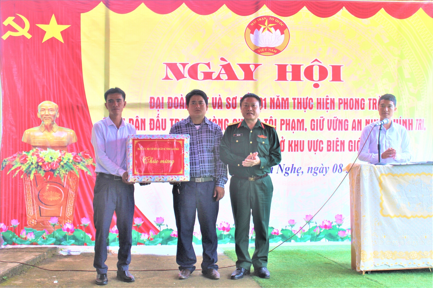 Đại tá Thào A Pinh, Chính ủy Bộ Chỉ huy quân sự tỉnh Lai Châu, tặng quà cho nhân dân bản Nậm Nghẹ