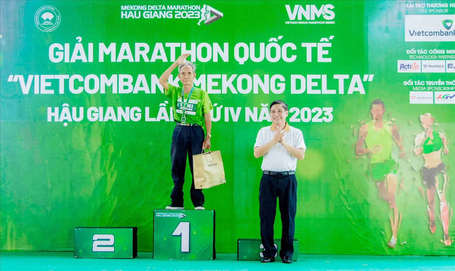 Ông Đồng Văn Thanh, Chủ tịch UBND tỉnh Hậu Giang trao quà cho người cao tuổi nhất tham gia Giải Giải Marathon Quốc tế “Vietcombank Mekong Delta” Hậu Giang lần thứ IV năm 2023