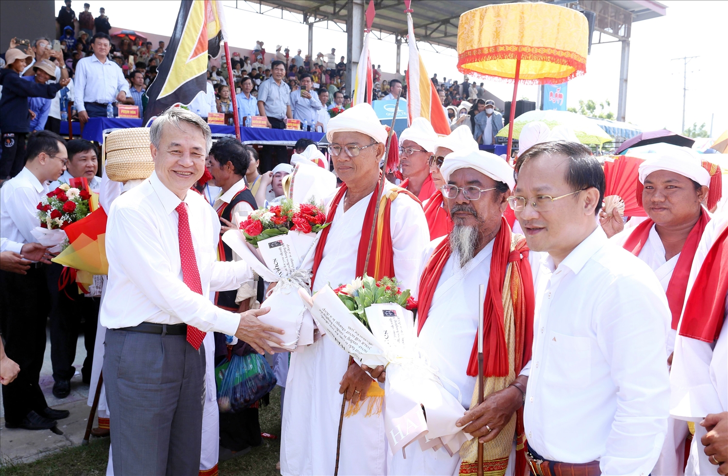 Ông Trần Minh Nam, Trưởng Ban Tuyên giáo Tỉnh ủy Ninh Thuận tặng hoa chức mừng các vị chức sắc làng Hữu Đức tại lễ rước y trang nữ thần Pô Inư Nưgar. 