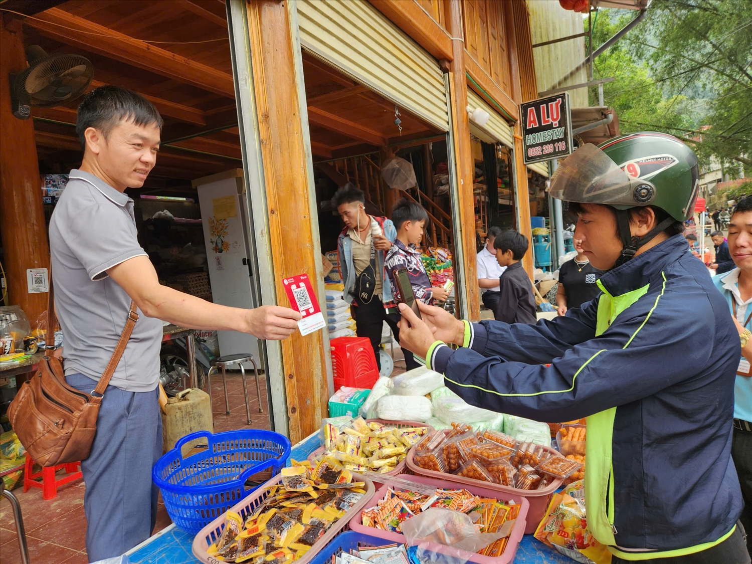 Người dân thanh toán không dùng tiền mặt tại chợ phiên xã Khâu Vai.