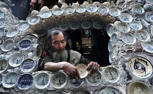 Ông Nguyễn Văn Trường gắn đĩa gốm cổ lên tường nhà