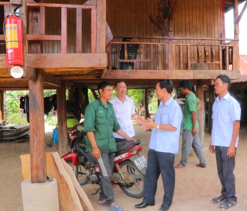 Anh Đinh Lech (áo xanh) ở làng Quel, xã Sró, huyện Kông Chro chia sẻ niềm vui khi được hỗ trợ kinh phí xây nhà ở khang trang