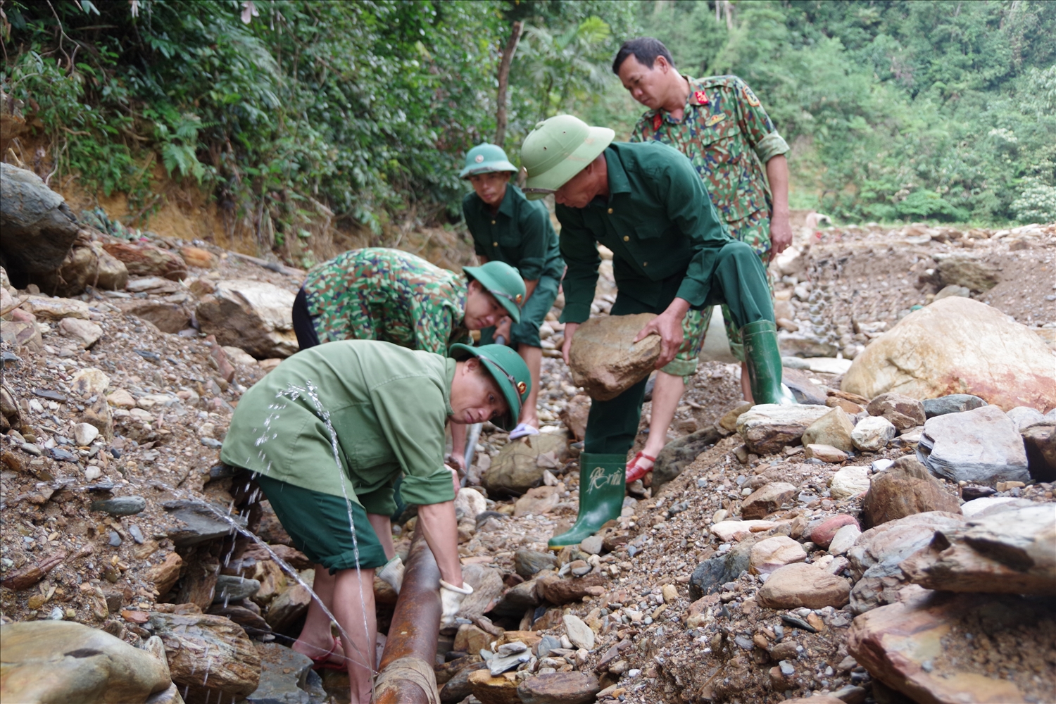 Trung tá QNCN Nguyễn Viết Hoàn cùng đồng đội lắp đường ống nước, đưa nước sinh hoạt về cho đồng bào trên địa bàn đóng quân.