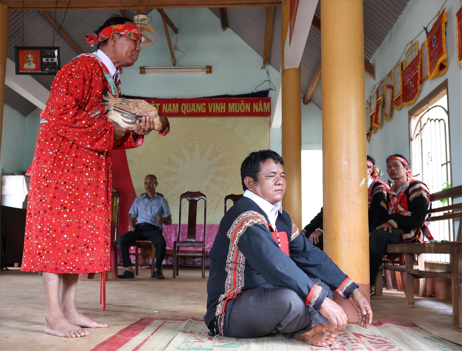 Nghi thức cúng sức khỏe chủ nhà (già làng là người đại diện buôn), lễ vật gồm 1 con gà sống và 1 chóe rượu cần.