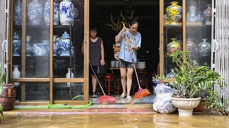 Người dân dọn dẹp nhà cửa sau lũ