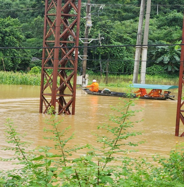 Công nhân Điện lực Na Hang đi thuyền kiểm tra hiện trường