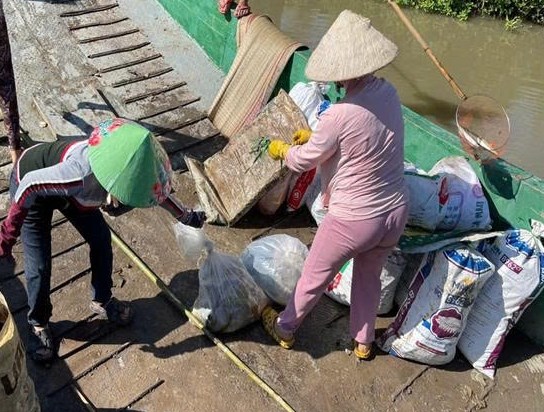 Bà con phân loại rác ngay trên ghe