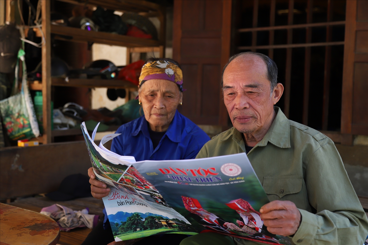 Người có uy tín Hoàng Văn Sang tìm hiểu thông tin trên báo để tuyên truyền vận động cho người dân trong thôn
