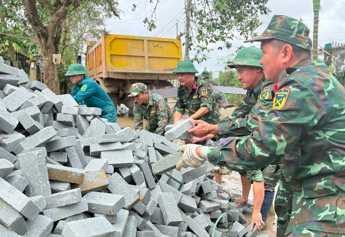 Chiến sỹ Đoàn Kinh tế - Quốc phòng 207/Quân khu 5 vận chuyển vật liệu xây nhà cho người dân. (Ảnh: T.Q)