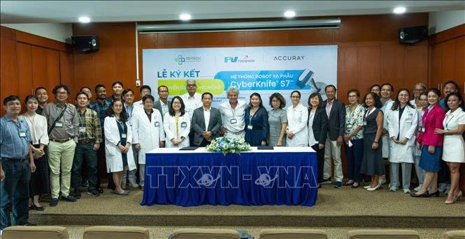 Lãnh đạo Bệnh viện FV kí kết mua bán và chuyển giao công nghệ với đại diện của Accuray - nhà sản xuất hệ thống xạ phẫu CyberKnife S7. Ảnh: TTXVN phát