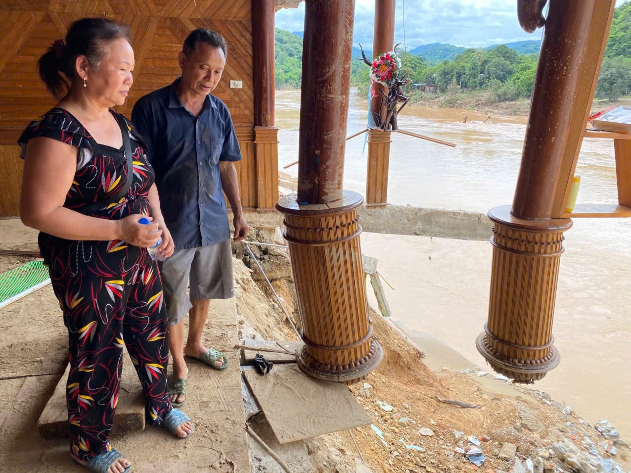 Vợ chồng ông Đậu Văn Sơn thẩn thờ nhìn ngôi nhà đã bị lũ phá hỏng