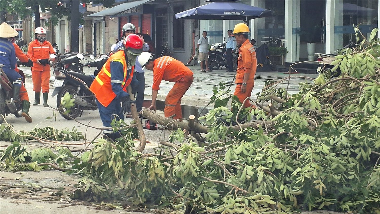 Lực lượng chức năng đang tiến hàng cắt cây để thông tuyến giao thông ở đường Phan Đình Phùng (Ảnh: Phạm Tiến)
