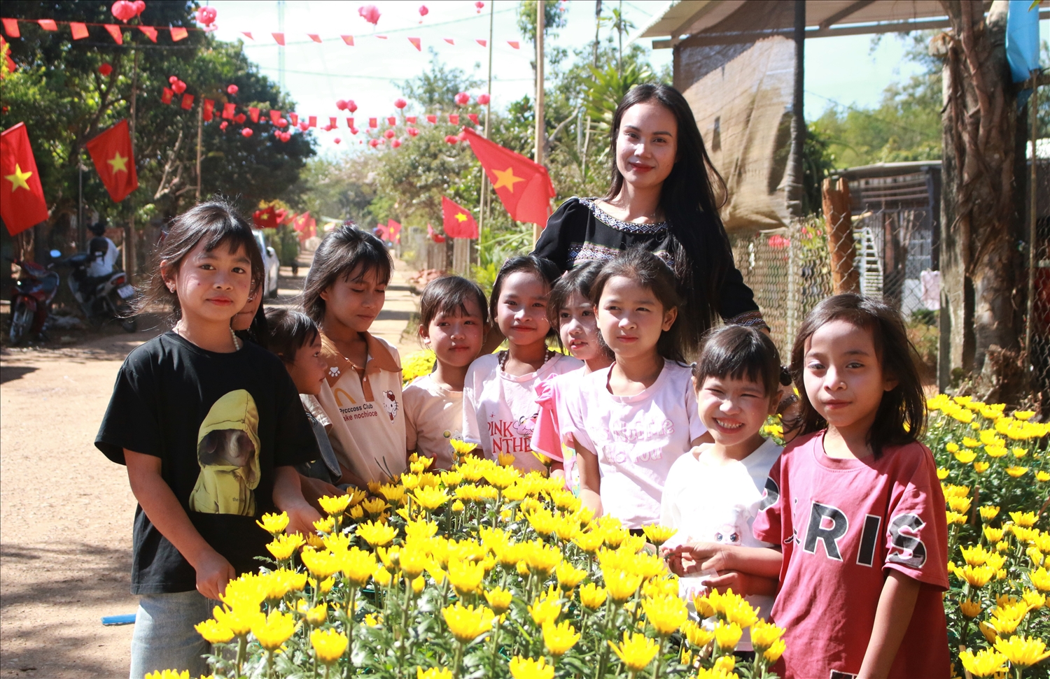 Chị Y Lệ (áo thổ cẩm), thôn Kon Gu 2 và các cháu trong thôn cùng nhau chụp những tấm ảnh đẹp để làm kỷ niệm. (Ảnh: Ngọc Chí)