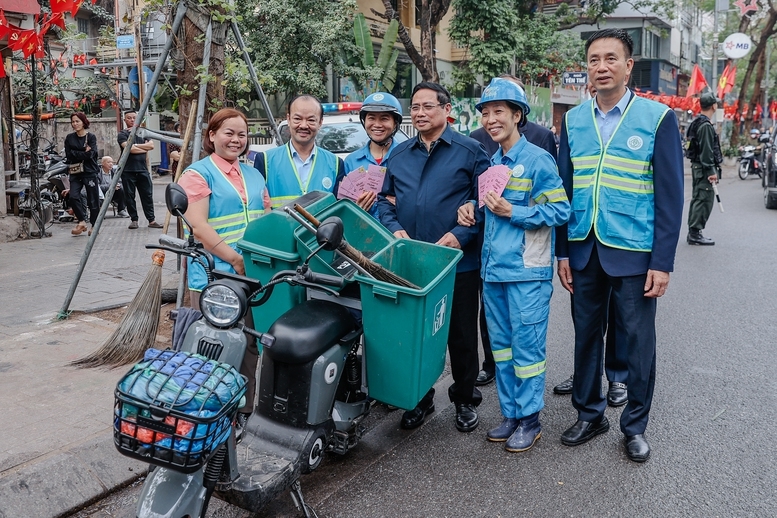 Thủ tướng thăm và động viên công nhân môi trường đô thị đang thực hiện nhiệm vụ tại Phố Nguyễn Thái Học - Ảnh: VGP/Nhật Bắc
