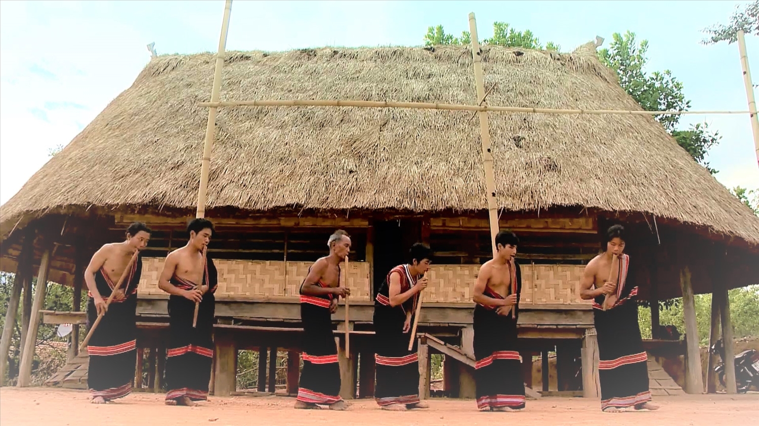 Người biễu diễn tay trái cầm đinh tút, tay phải ép sát vào ngực, tạo nên tư thế của thân hình nghiêng xuống với mặt đất và lắc lư theo nhịp. (Ảnh: Ngọc Chí)