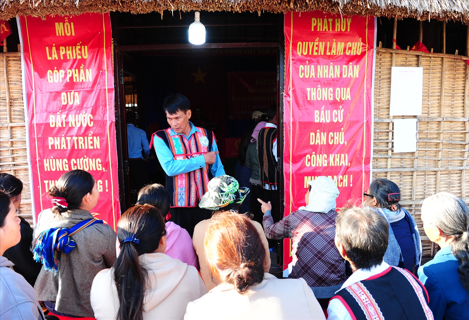 Ông A Bát, thành viên tổ bầu cử số 2, xã Ngọc Bay hướng dẫn tỉ mỉ bà con quy trình bỏ phiếu.
