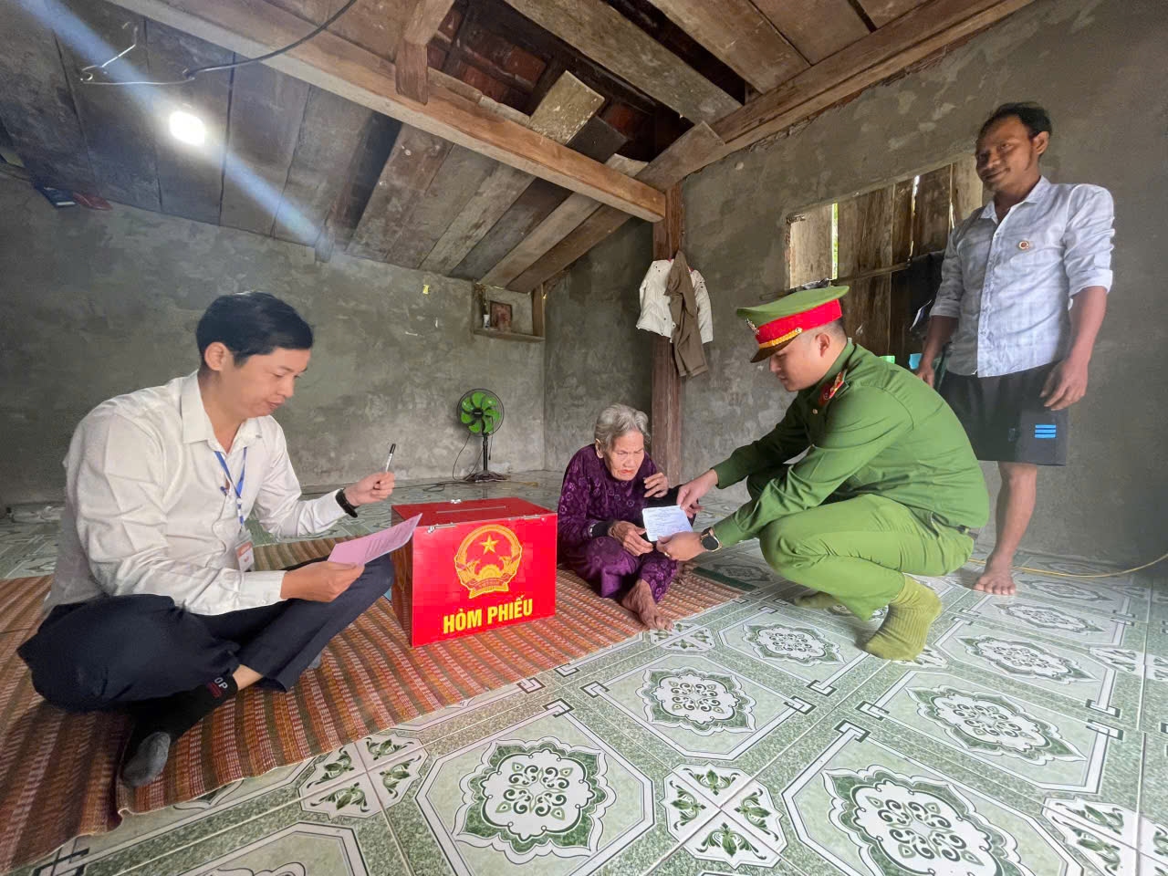 Xã Trà Tân mang hòm phiếu đến với cử tri lớn tuổi. (Ảnh LN)