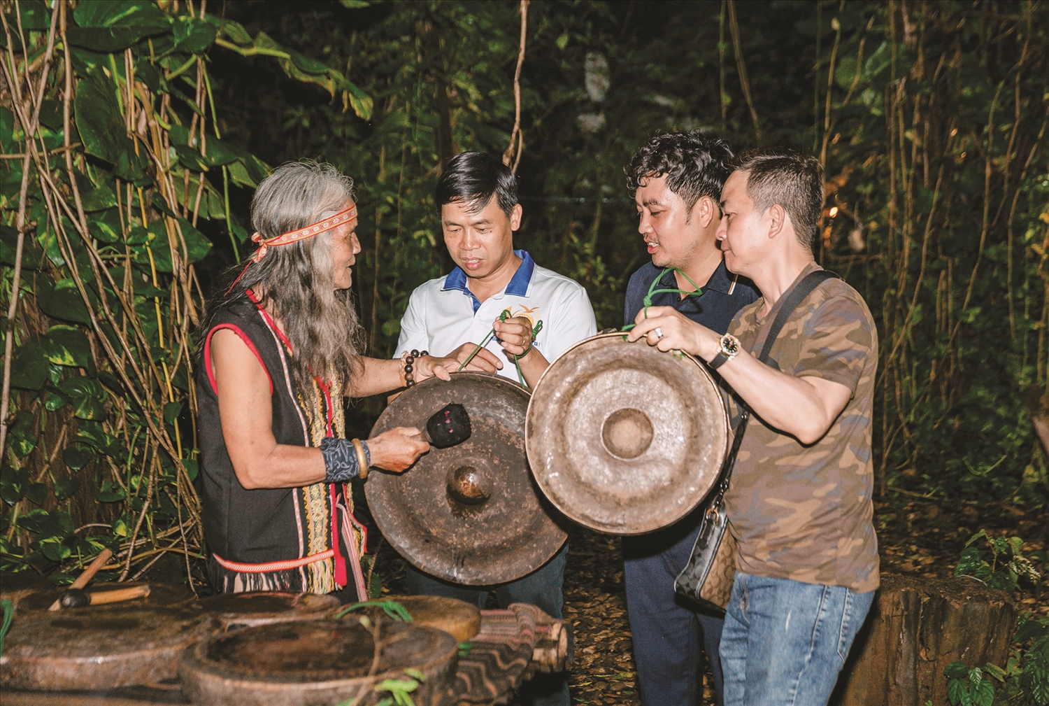 Nghệ nhân Ưu tú A Biu (áo thổ cẩm), làng Plei Klếch, xã Ngọk Bay giới thiệu với du khách về bộ chiêng quý của người Ba Na do ông đang gìn giữ