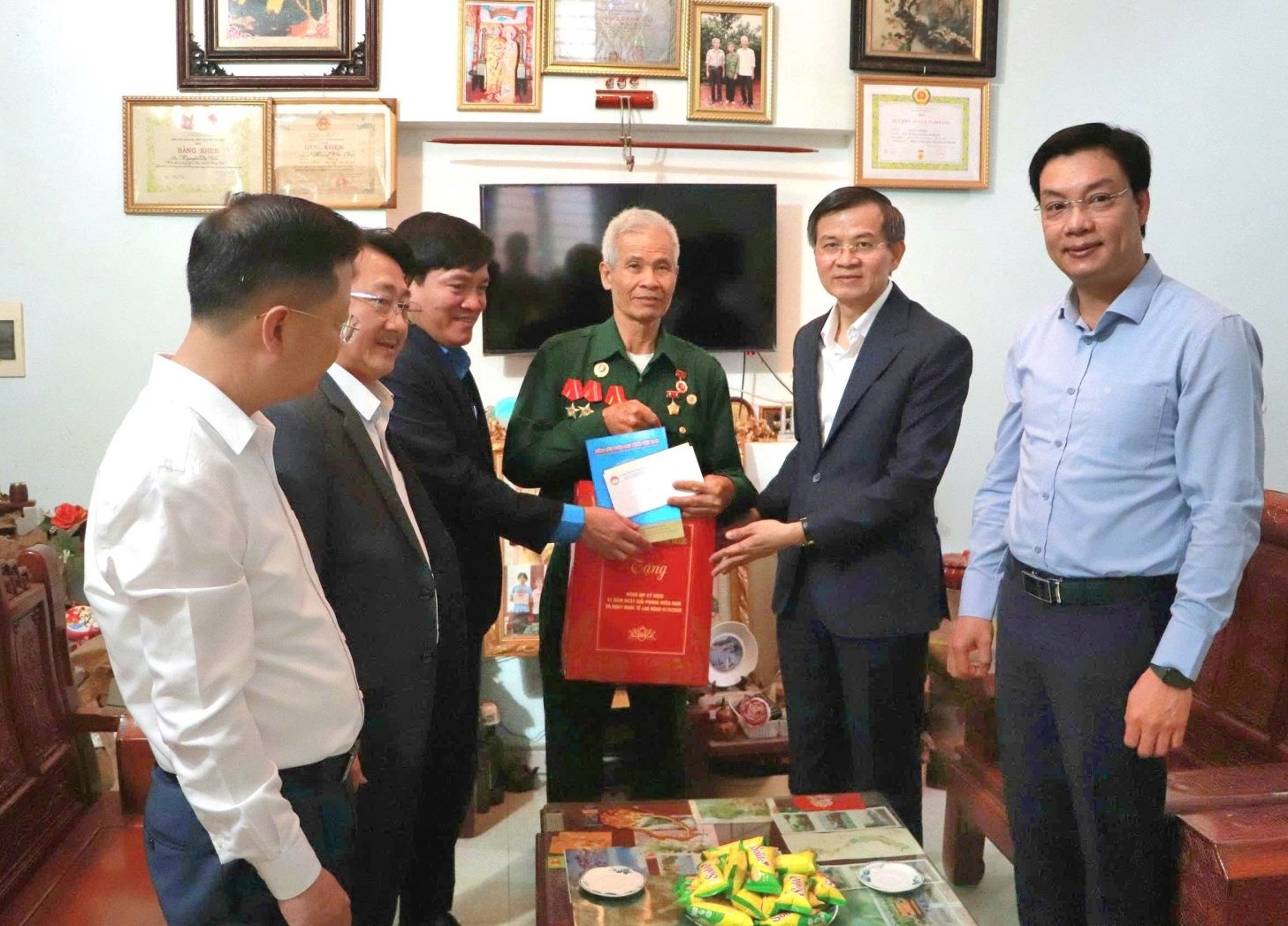 Đồng chí Đoàn Minh Huấn thăm, tặng quà ông Hoàng Văn Giáp là người có công ở phường Đoàn Kết (Ảnh Cổng TTĐTLC)