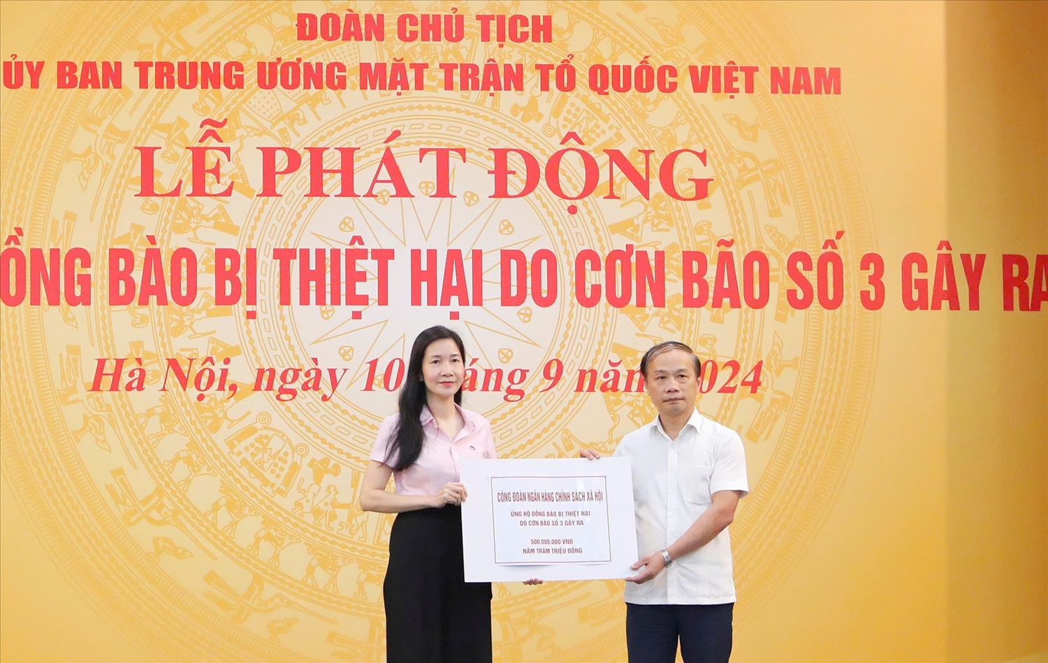 Phó Tổng Giám đốc NHCSXH Nguyễn Thị Hằng (bên trái) trao biểu trưng cho đại diện Lãnh đạo MTTQ Việt Nam