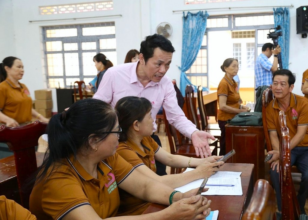 Phó Tổng Giám đốc NHCSXH Việt Nam Hoàng Minh Tế kiểm tra việc thực hiện giao dịch qua App của tổ tiết kiệm và vay vốn trên địa bàn tỉnh
