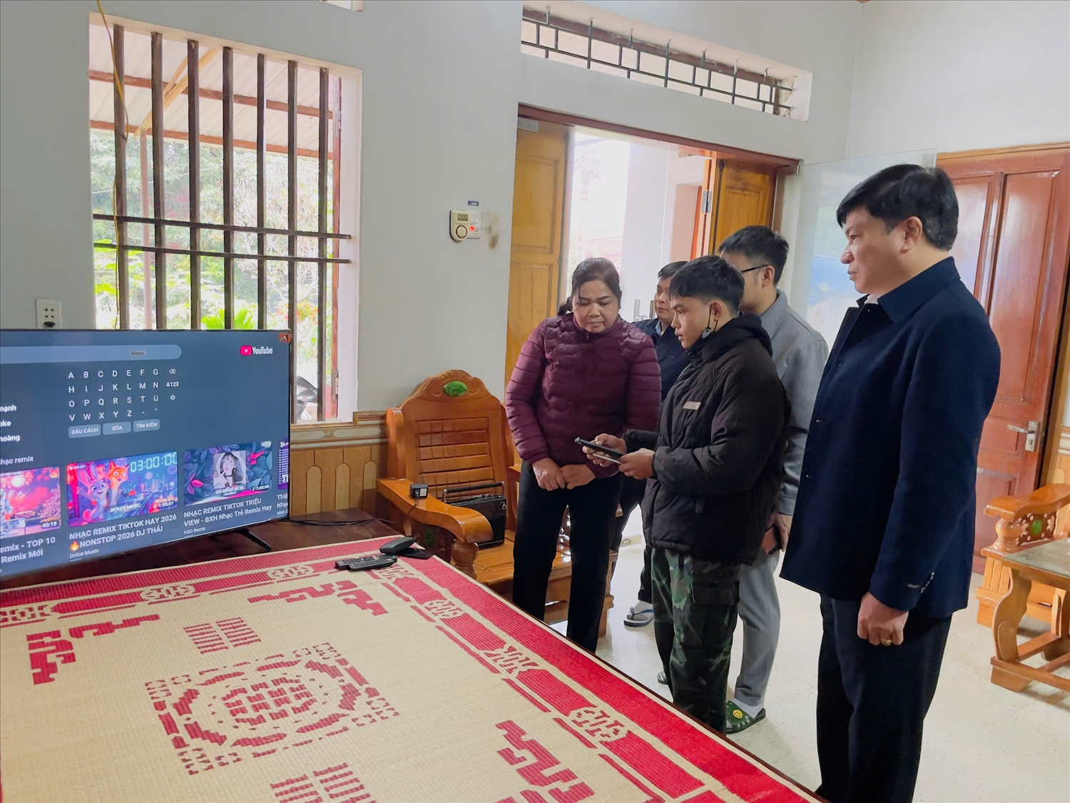 Bàn giao và hướng dẫn lắp đặt tivi cho bà Hoàng Thị Bình (áo tím), Người có uy tín tại xóm Tân Lập, xã Định Hóa, tỉnh Thái Nguyên.